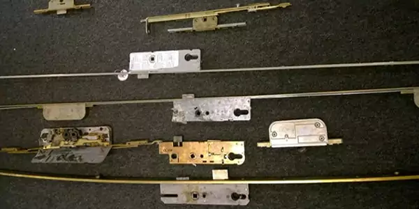 uPVC Door Lock Repair Sheffield set of five removed multi-point locking mechanisms against a new lock mechanism at the top