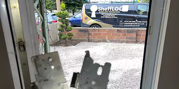 uPVC Door Repair Sheffield open doorway with new and old multipoint locks and SHeffLOCK van in the background